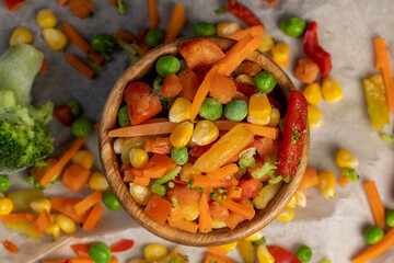 a mixture of quick-frozen corn, peas, peppers, and carrots