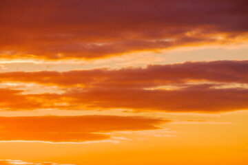 cloudy weather meteorology background. cumulus clouds on the blue sky blown by the wind. orange glow