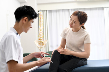 脚の痛みで悩む女性患者と話す白衣姿の男性