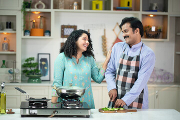 Couple Cooking Together Healthy Food In  Kitchen At Home