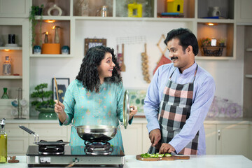 Romantic Couple Cooking Together In Kitchen
