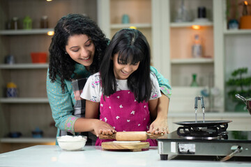 Mother Helping Her Daughter Preparing Chapati