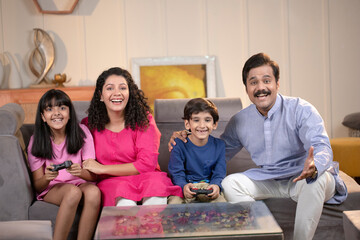 Children Playing Video Game With Parents