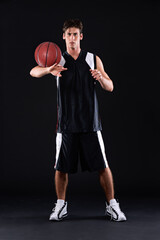 Naklejka premium Basketball, portrait and man in dark studio for sports, fitness exercise or training for strong body. Male athlete, black background and workout for game in gym, night with health and wellness