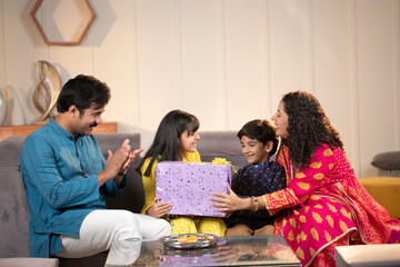 Man Clapping While His Son Giving Gift To His Daughter