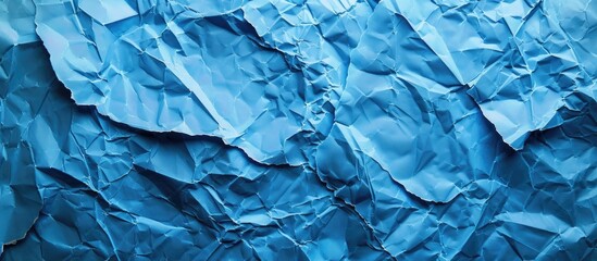 Fototapeta premium Background with blue crumpled paper texture providing copy space image.