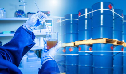 Analysis of chemical composition of oil. Laboratory assistant near barrels of fuel. Checking...