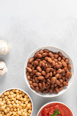 Boiled brown kidney beans on plate and cook ingredients. Copy space