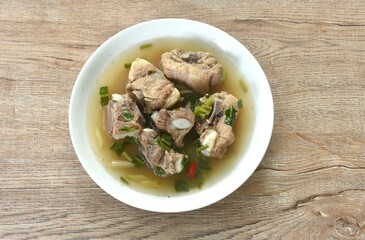 hot and spicy pork bone with tamarind and Thai herbs soup on plate