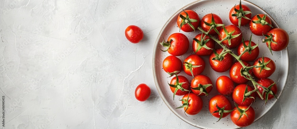Aufkleber cherry tomatoes beautifully arranged on a plate against a white table with ample copy space image.