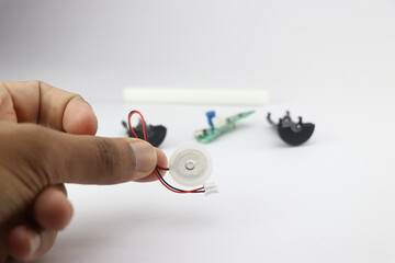 Humidifier mist maker that uses piezoelectric plate held in the had with its other parts in the...