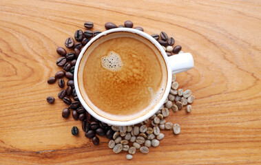Crema espesso coffee cup, espresso  coffee and coffee bean on wooden table