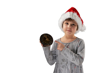 Christmas night. A cute child in a Santa Claus hat holds a clock and reminds that there are 5...