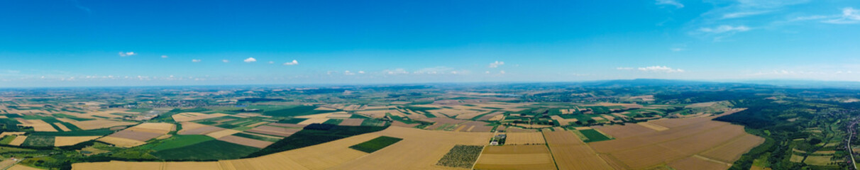 Aerial view of a countryside with cultivated fields. Panoramic view of a rural area with different agricultural crops