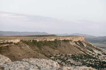 panoramic desert cliff view majestic mountains rising from arid landscape in golden light