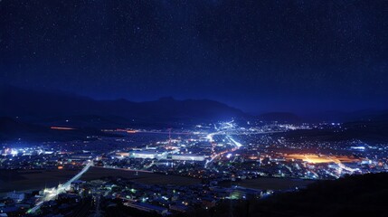 Fototapeta premium A city valley illuminated at night under a starry sky
