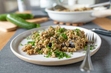 Brown rice with vegetables and eggs. Delicious vegetarian meat with eggplant and zucchini on a plate