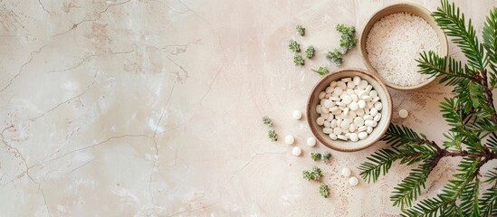 A bowl containing pills and plant branches arranged on a beige tile background with empty space for imagery. image with copy space
