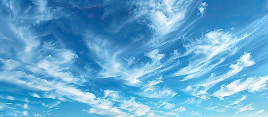 Fototapeta premium A picturesque sky with wispy white clouds, providing ample copy space for text insertion.