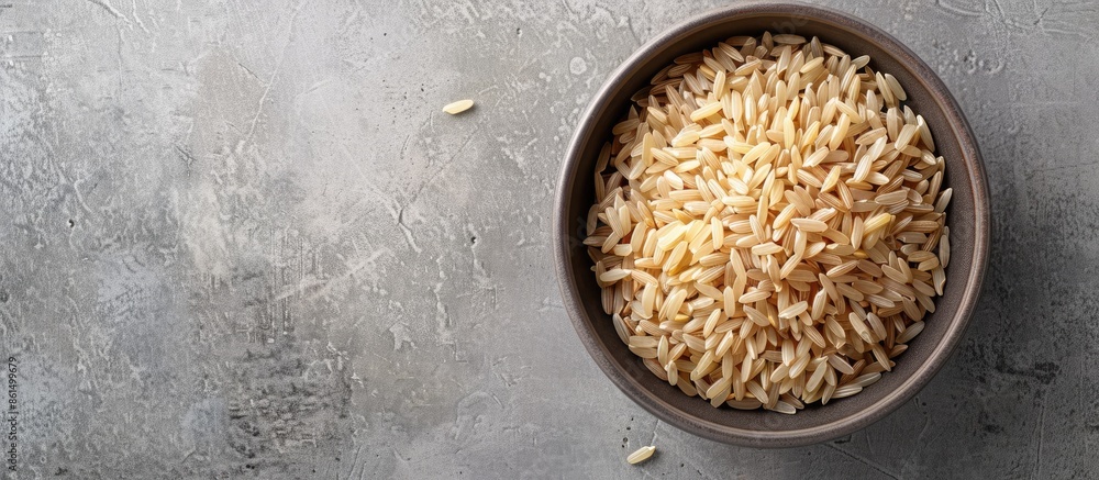 Poster a bowl containing uncooked brown rice with a plain background perfect for adding text or other eleme