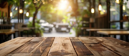 A wooden table with a blurred background in a cafe or coffee shop, suitable for displaying or montaging your products, alongside a copy space image.