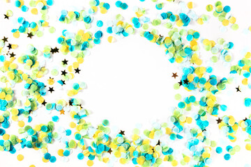 Happy birthday or any holiday festive background with confetti and copy space. Carnival greeting card with golden stars, a frame on a white background