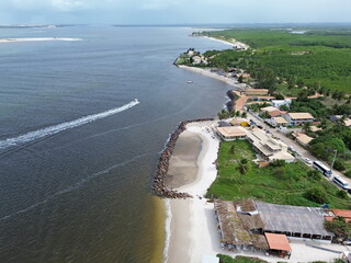 Aerial view of Praia do Saco, tourititc place near Aracaju city, Brazil. White sand beach, green vegetaion, constructions and sea water