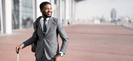 Waiting fot Taxi. Afro Businessman Arriving To Airport, Standing Outdoors with Baggage