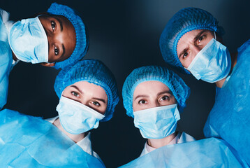 Team of Professional Surgeons Looking At Patient With Difficult Case Lying On Operating Table,...