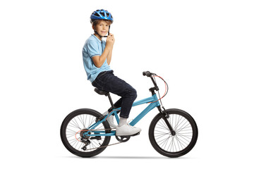Obraz premium Boy putting on a helmet and sitting on a bicycle
