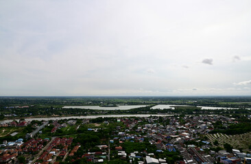 NAKHONSAWAN, THAILAND - JULY 1, 2024: High angle view, viewpoint of Nakhonsawan city and Thai Buddhist Temple with Blue sky with white cloud. Clear day and good weather in the morning.