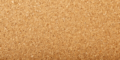 Close-up of cork board texture with a uniform, granular surface, showing the natural pattern and earthy brown tones.