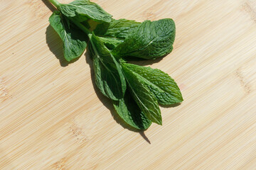 fresh mint leaves on wooden background