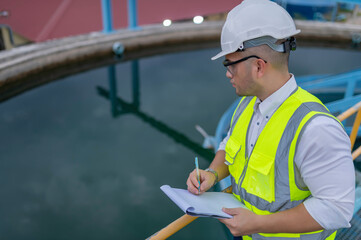 Fototapeta premium Environmental engineers work at wastewater treatment plants,Water supply engineering working at Water recycling plant for reuse