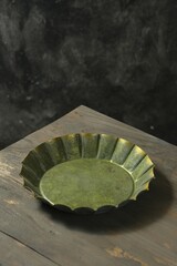 Empty ustic and vintage plate on the table with dark background. Piring © Rezmita