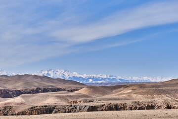 View of upper edges of Black Canyon. Snowy peaks of Zaili Alatau mountains, Kazakhstan.