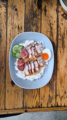 Crispy pork rice on a blue plate on the dining table