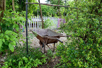 Closeup of The cement cart is no longer in use and sits in the garden with natural background at Thailand.