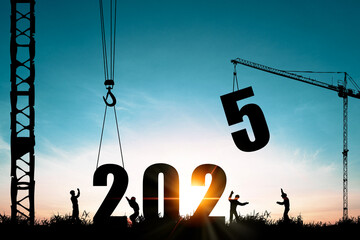 ilhouette of construction worker with crane and cloudy sky for preparation of welcome 2025 new year...