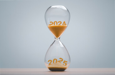 2024 falling sand taking the shape of a 2024 in hourglass for Countdown to New Year 2025 concept.