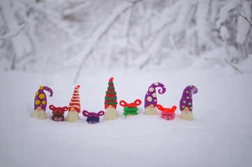 Smiling gifts made of plasticine on a background of snow.