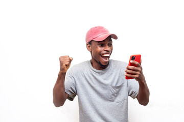 Overjoyed African man using smartphone sports betting, win money isolated on white background....