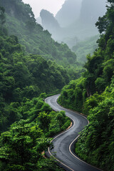 A picturesque scene of an asphalt road winding through lush green forests against the backdrop of majestic mountains. tranquil landscape captures the serene beauty of nature in the region,
