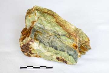 Sample of Archean age interbedded barite and chert with scale.