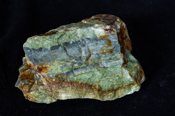 Sample of Archean age interbedded barite and chert on a black background