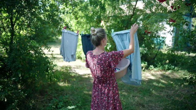 Clothes hang on clothesline and dry in backyard after washing