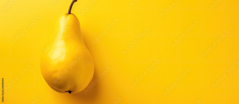 Poster close up view of a single ripe pear on a vibrant yellow background, embodying an autumn fruit theme 