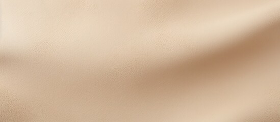 Fototapeta premium Close-up view of a light beige matte suede background showcasing a seamless sand leather texture, ideal for a copy space image.