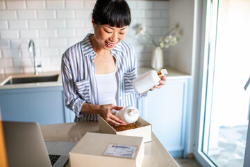 Asian Woman Unpacking Online Delivery in Kitchen
