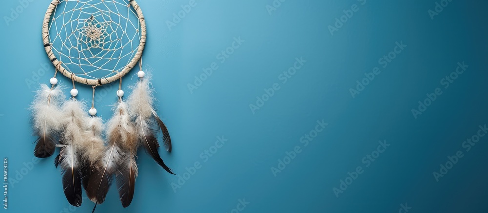 Poster Top view of a dream catcher feature Asian attributes on a blue background with copy space image available.